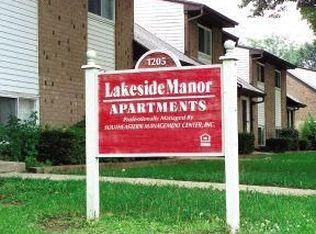 a red and white sign in front of a house